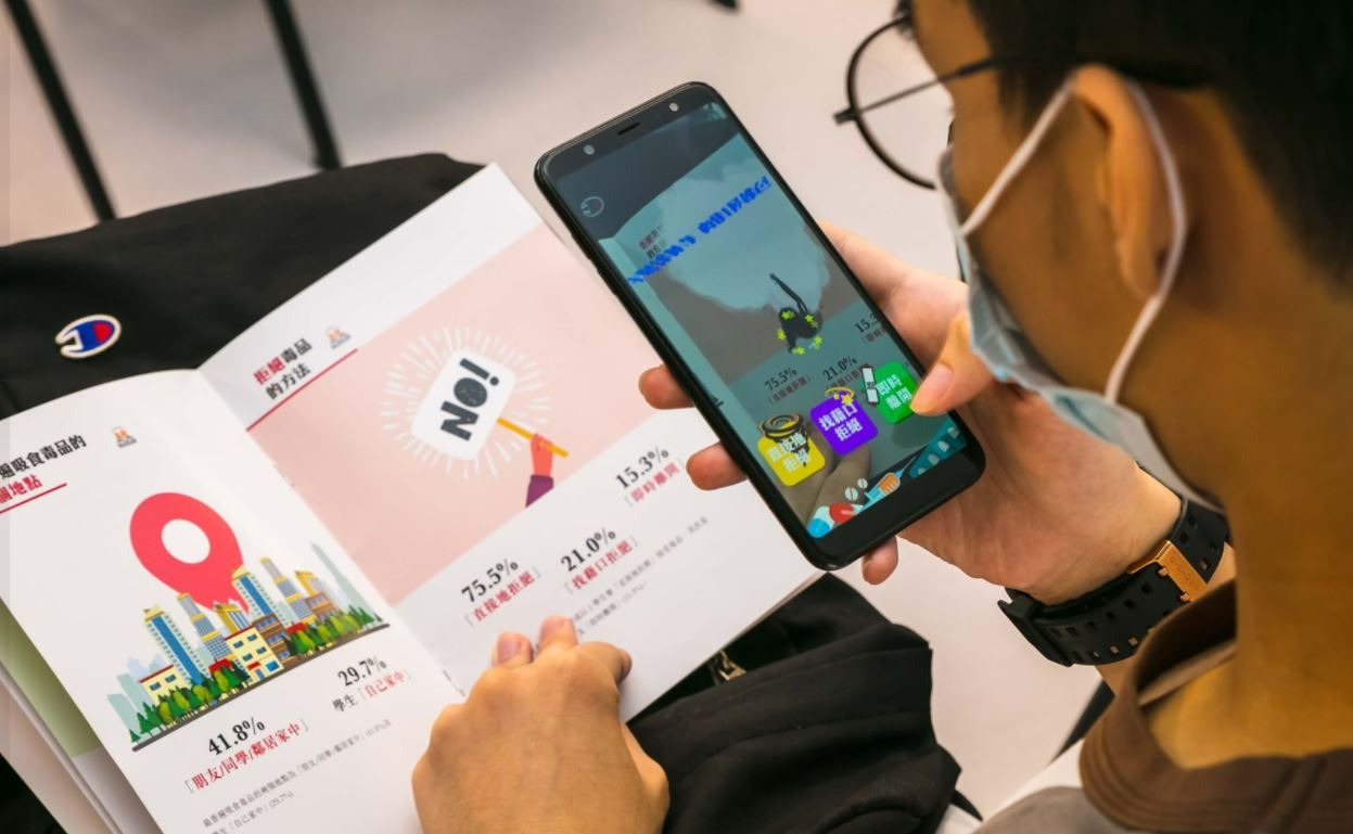Learner using an augmented-reality book experience